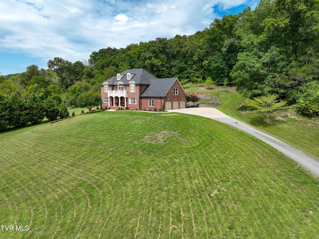 view of front of house featuring a garage and a front lawn