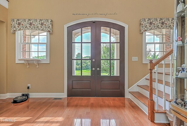 doorway to outside featuring french doors, hardwood / wood-style floors, and a wealth of natural light