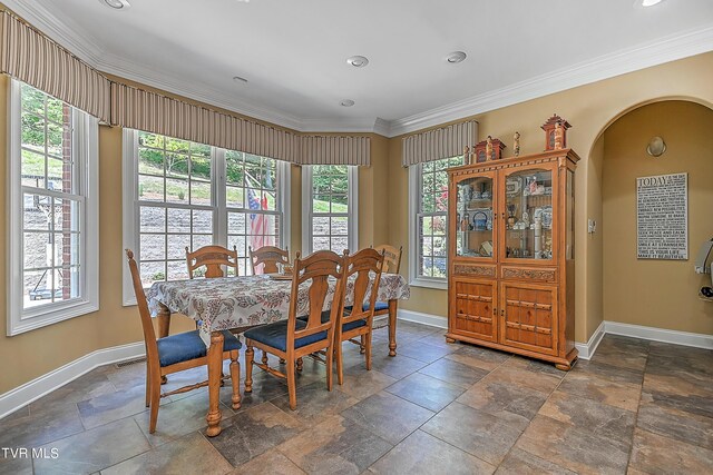 dining space with crown molding