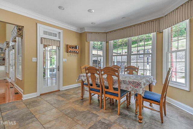 dining space featuring crown molding