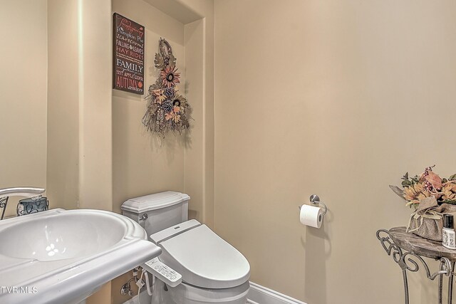 bathroom featuring sink and toilet