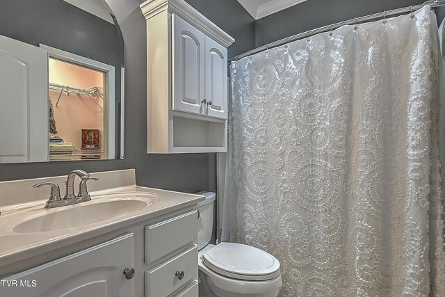 bathroom featuring vanity, a shower with curtain, ornamental molding, and toilet