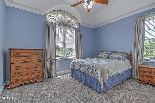 carpeted bedroom featuring crown molding and ceiling fan