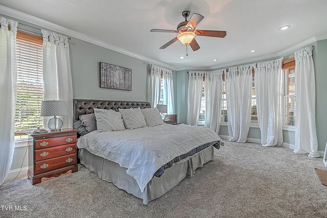 bedroom with crown molding, light colored carpet, and ceiling fan