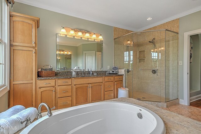 bathroom with independent shower and bath, vanity, and crown molding