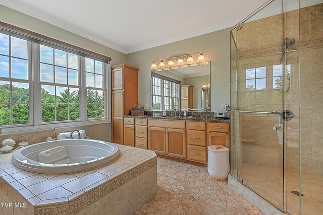 bathroom with vanity, ornamental molding, and shower with separate bathtub