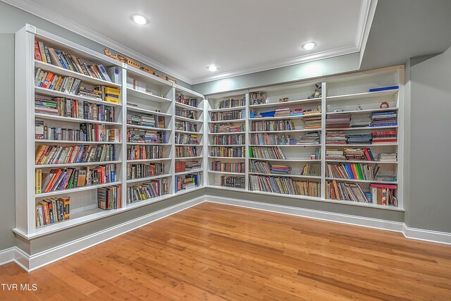 unfurnished room featuring ornamental molding and hardwood / wood-style floors