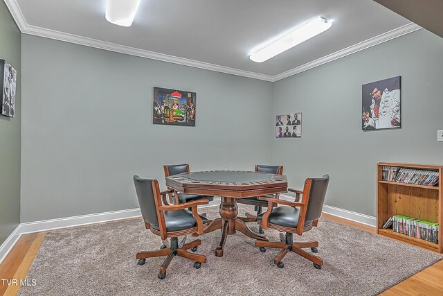 dining area featuring hardwood / wood-style flooring and ornamental molding