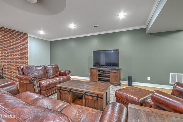 living room featuring ornamental molding, brick wall, and hardwood / wood-style floors