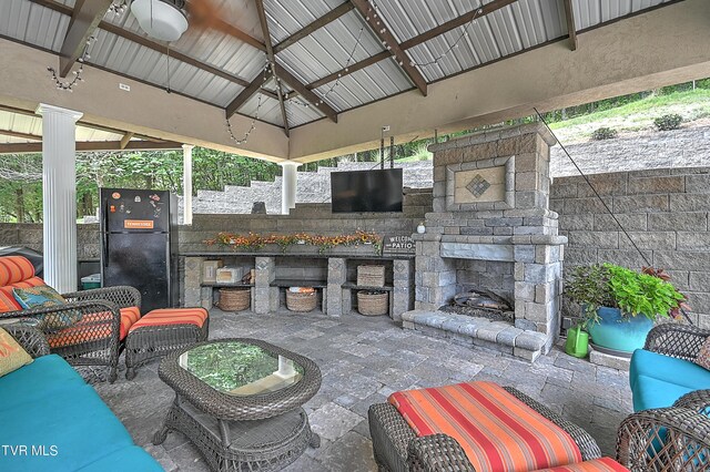 view of patio / terrace featuring a gazebo and an outdoor living space with a fireplace