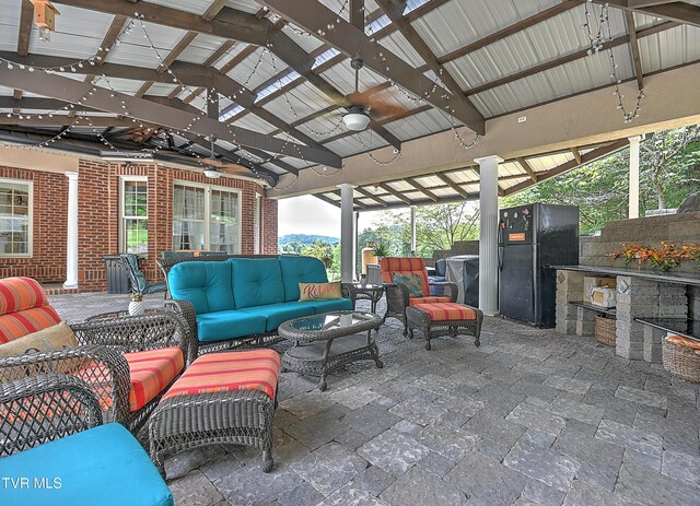 view of patio featuring outdoor lounge area, exterior kitchen, an outdoor bar, ceiling fan, and a gazebo