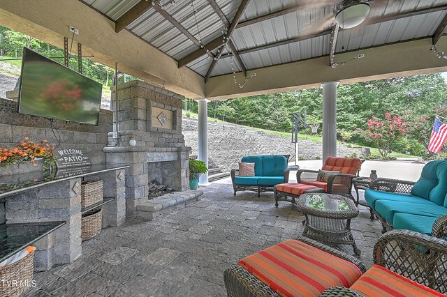 view of patio / terrace featuring a gazebo and an outdoor living space with a fireplace