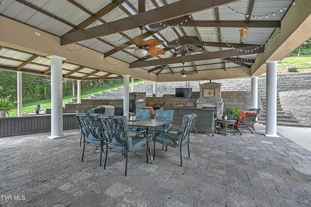 view of patio / terrace featuring ceiling fan, a gazebo, and exterior fireplace