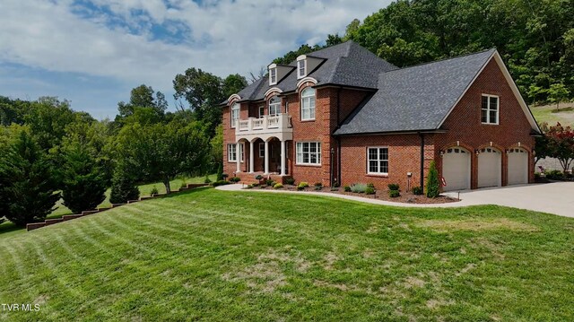 french country home with a garage and a front yard