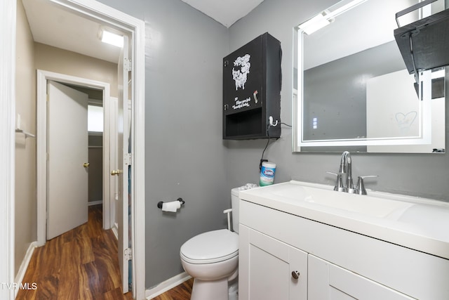 bathroom with vanity, wood-type flooring, and toilet