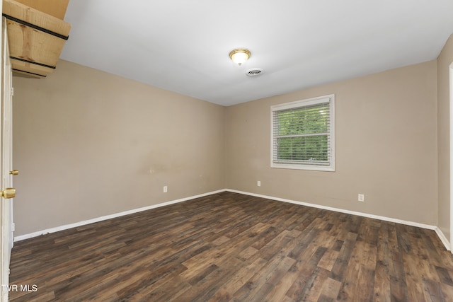 empty room with dark wood-type flooring