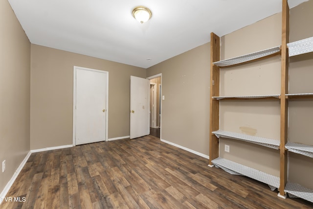 unfurnished bedroom with dark hardwood / wood-style floors