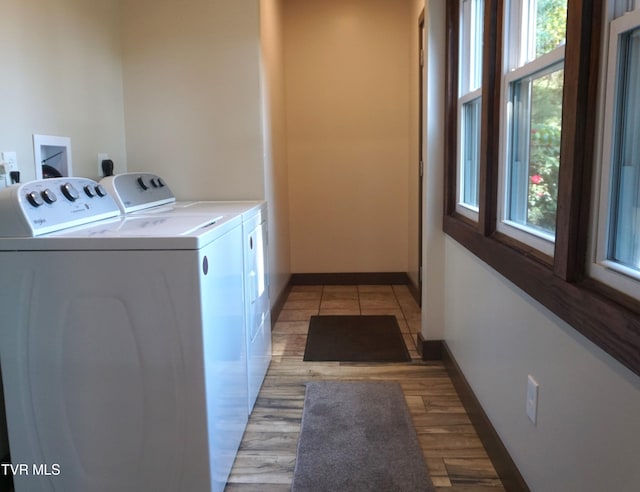 washroom with light hardwood / wood-style flooring and independent washer and dryer