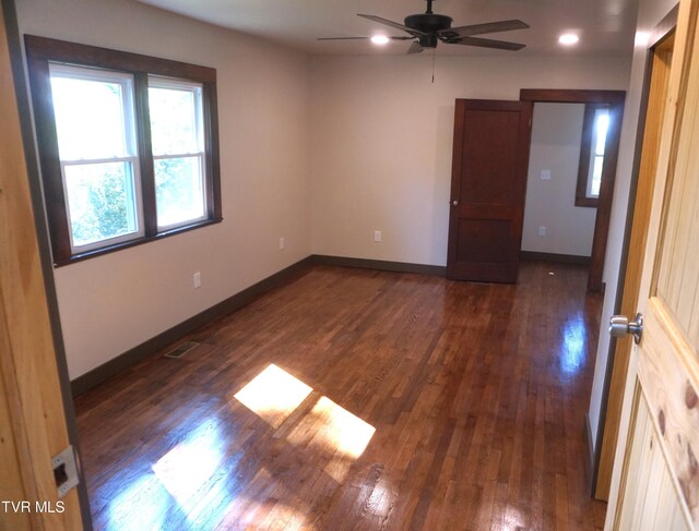 unfurnished room featuring ceiling fan and dark hardwood / wood-style floors