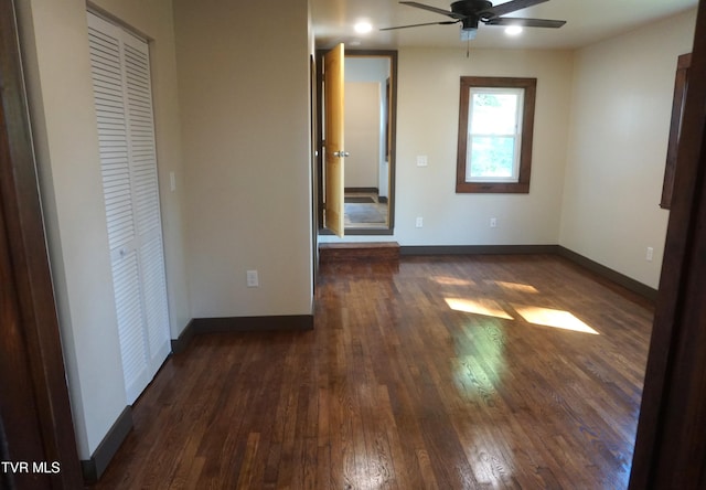 unfurnished bedroom featuring dark hardwood / wood-style flooring and ceiling fan