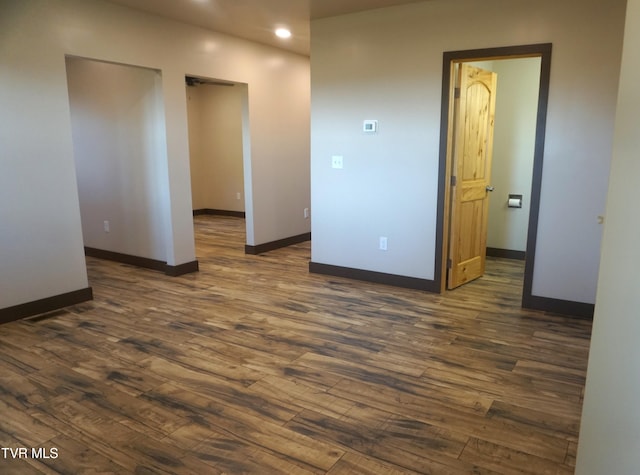 spare room with dark hardwood / wood-style floors