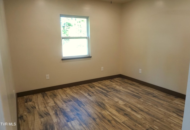 spare room with dark hardwood / wood-style floors