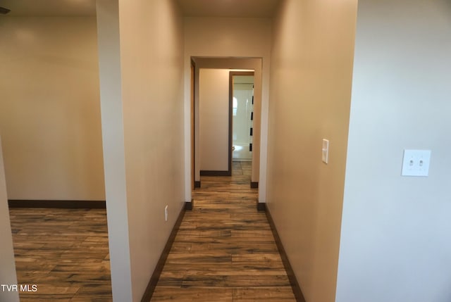 hallway with dark wood-type flooring