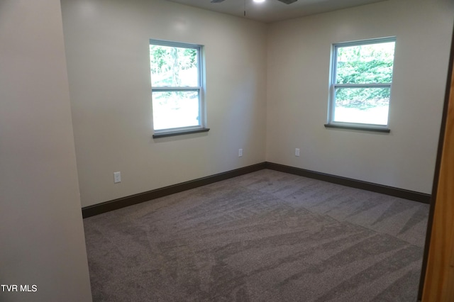 empty room featuring carpet flooring and ceiling fan