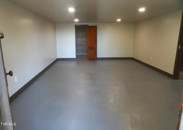 unfurnished room featuring concrete floors