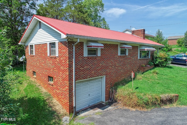 view of home's exterior featuring a garage and a lawn