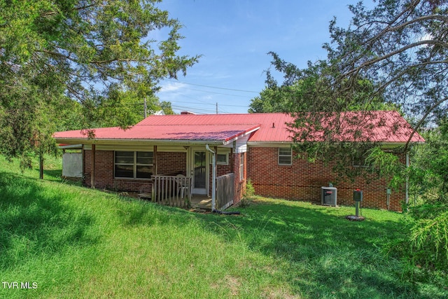 back of property featuring a lawn