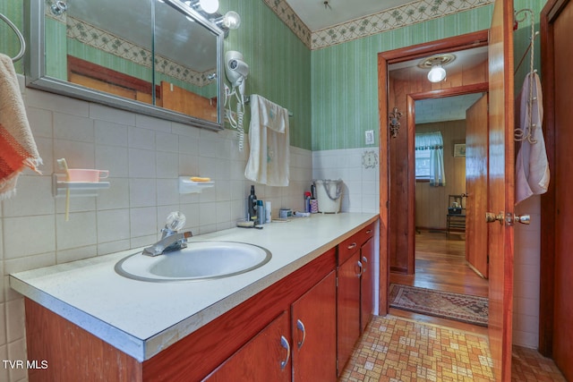 bathroom featuring tile walls, tasteful backsplash, vanity, and wood-type flooring