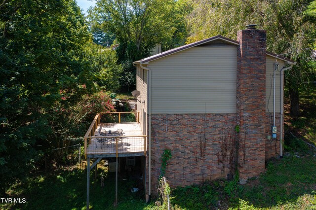 view of side of home with a deck