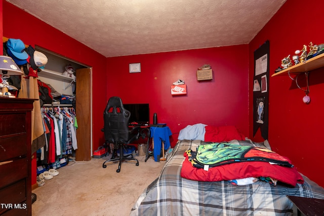 carpeted bedroom featuring a closet and a textured ceiling