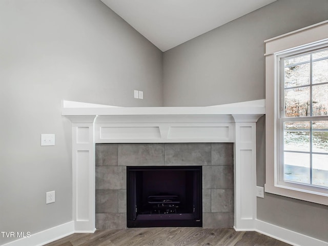 interior details with hardwood / wood-style flooring and a fireplace