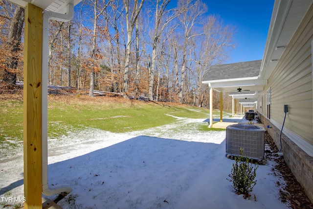 view of yard featuring ceiling fan, cooling unit, and a patio