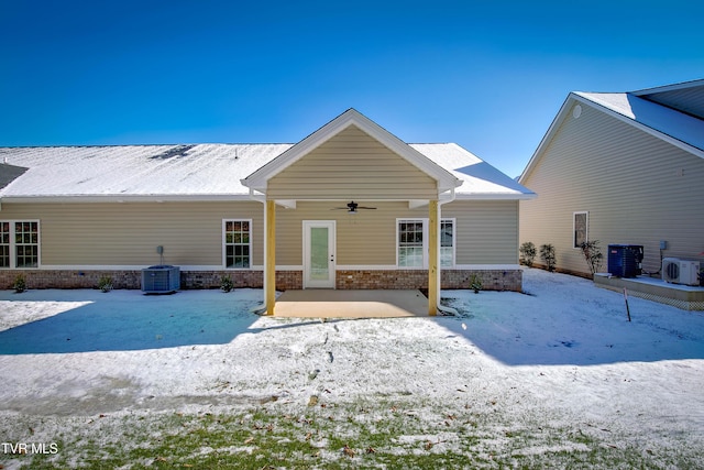 snow covered property with ac unit, central AC unit, and ceiling fan