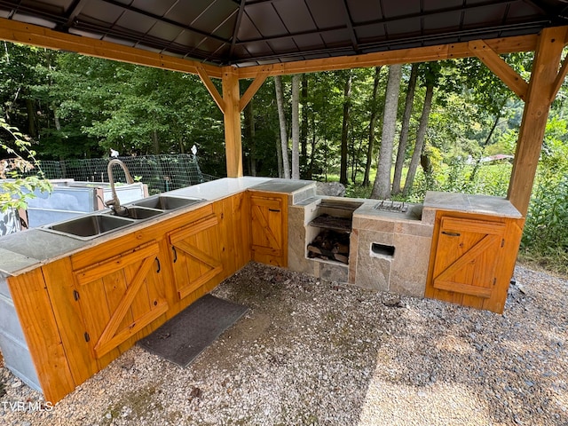 view of patio featuring a gazebo, exterior kitchen, and sink