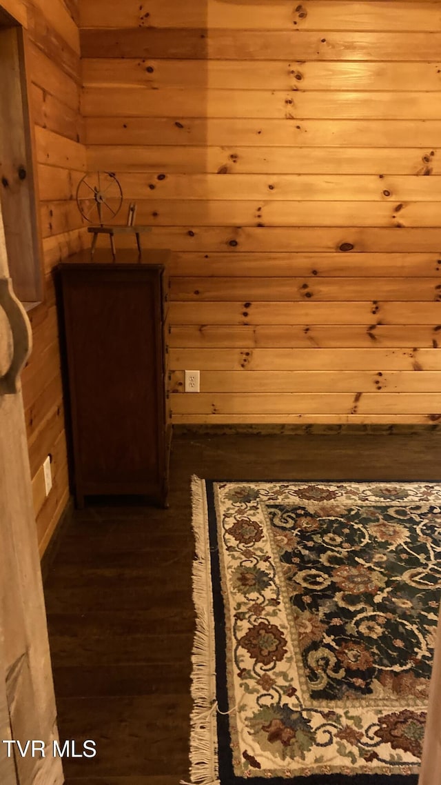 hall featuring wood walls and dark hardwood / wood-style flooring