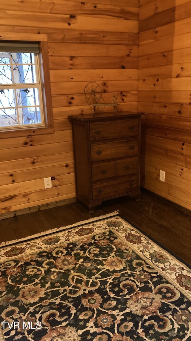 interior space featuring wood walls and dark hardwood / wood-style flooring