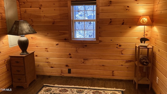 interior space featuring dark hardwood / wood-style flooring and wooden walls