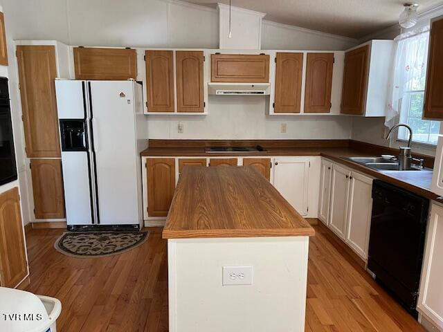 kitchen with under cabinet range hood, a sink, a center island, black appliances, and dark countertops