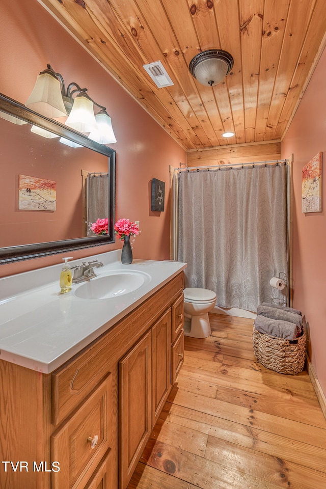 bathroom featuring vanity, toilet, wooden ceiling, walk in shower, and hardwood / wood-style floors