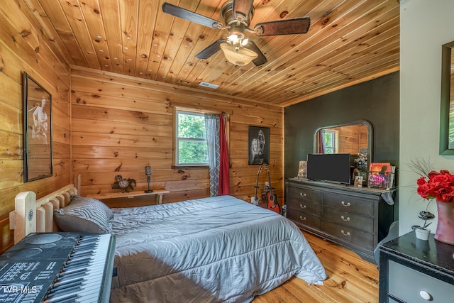 bedroom with light hardwood / wood-style flooring, wood ceiling, wood walls, and ceiling fan