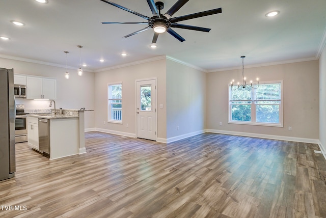 kitchen with ceiling fan with notable chandelier, light wood-type flooring, white cabinetry, and appliances with stainless steel finishes