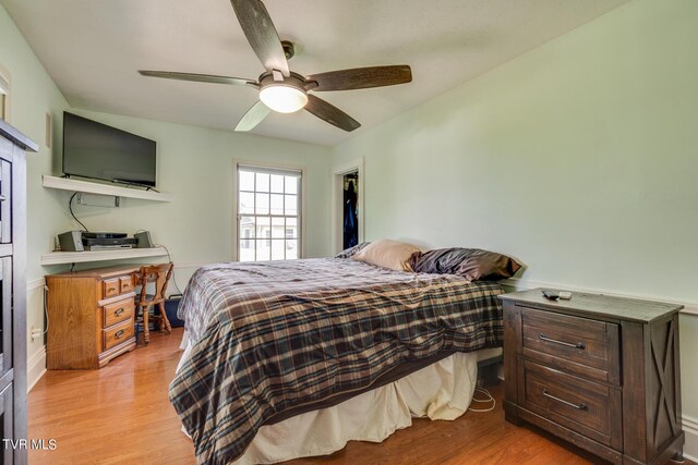 bedroom with ceiling fan and light hardwood / wood-style floors