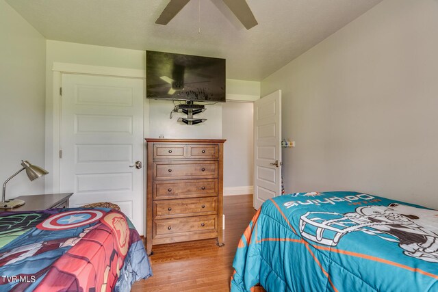 bedroom with ceiling fan and hardwood / wood-style flooring