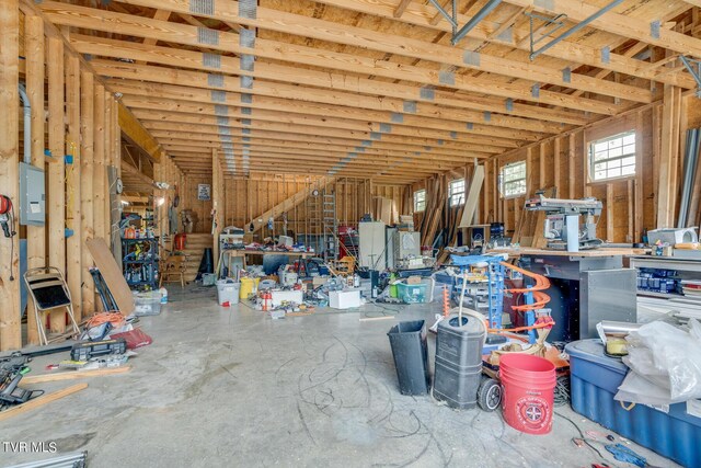 miscellaneous room with a workshop area and concrete flooring