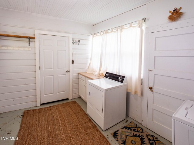 washroom with washer and clothes dryer and cabinets