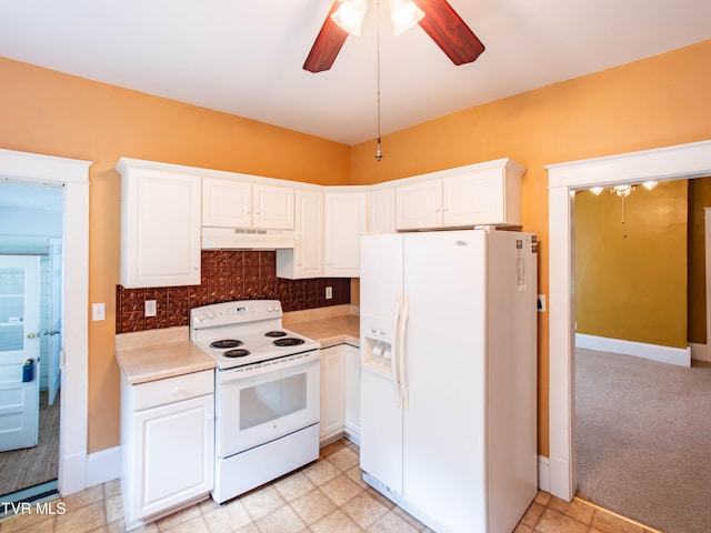 kitchen featuring ceiling fan, wall chimney exhaust hood, white cabinetry, light tile patterned floors, and white appliances